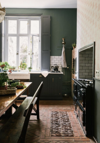 Kate Watson-Smyth takes a look at reclaimed materials for flooring. In this victorian rectory kitchen by deVol the herringbone floor is enhanced by a 'rug' style insert of textured tiles creating interest and a focal point. #victoriankitchen #reclaimedfloor #katewatsonsmyth